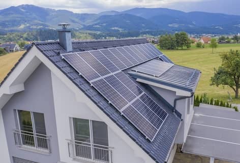 House with solar panels in valley